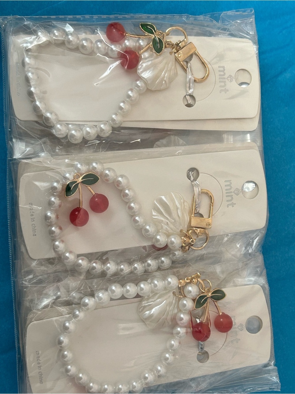 4/$100 Mint Red Cherry Charm Pearl keychain with Green Leaf Accent